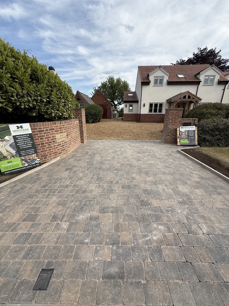 Block-paved driveway with charcoal edging completed by Heritage Paving