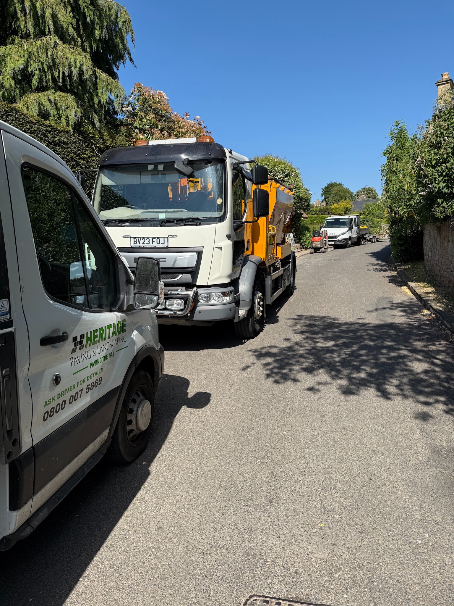 Heritage Paving van beside a tarmac hot box on site