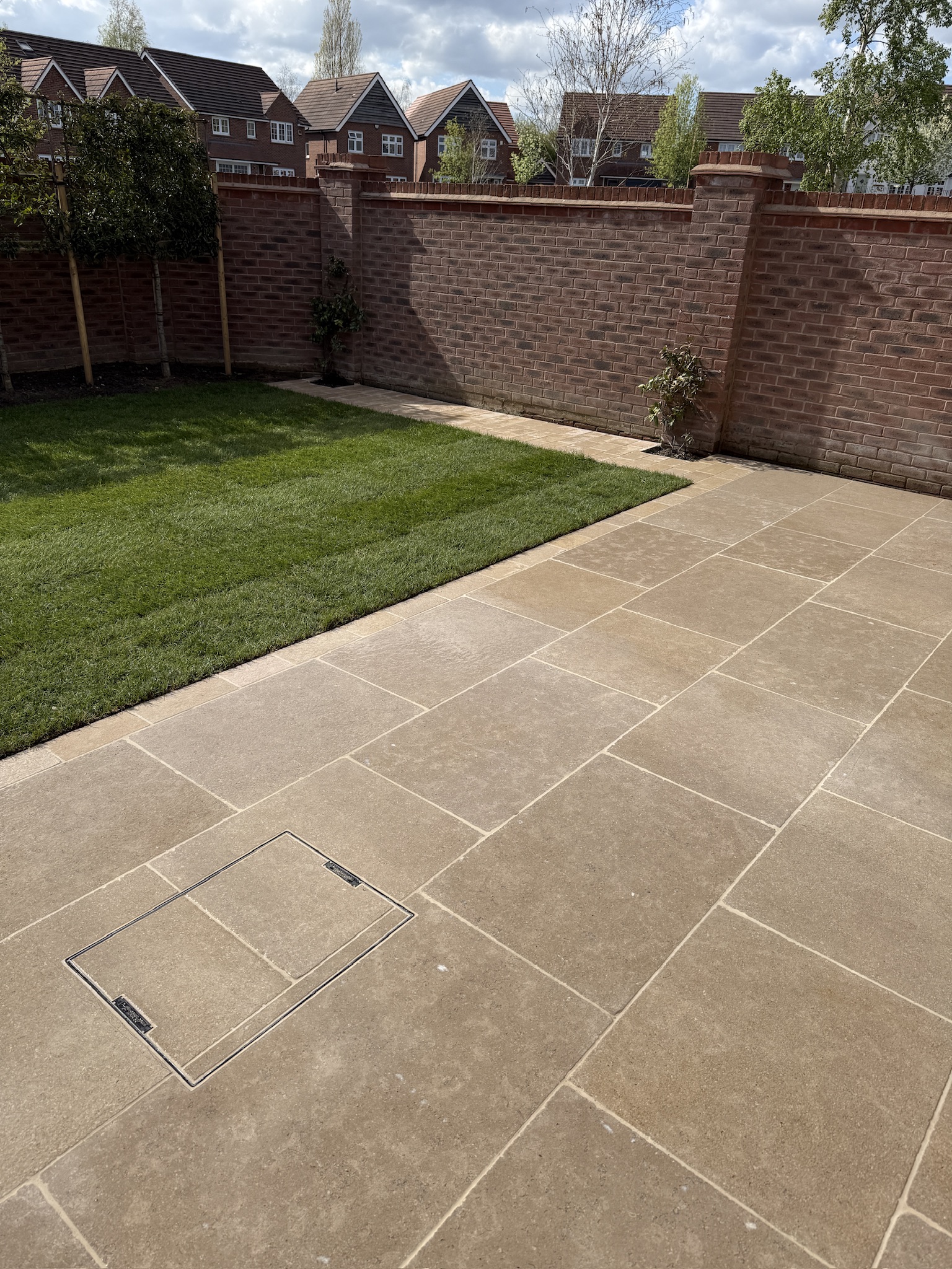 Egyptian limestone patio in Wakefield showing natural stone texture, precise joints and a recessed cover