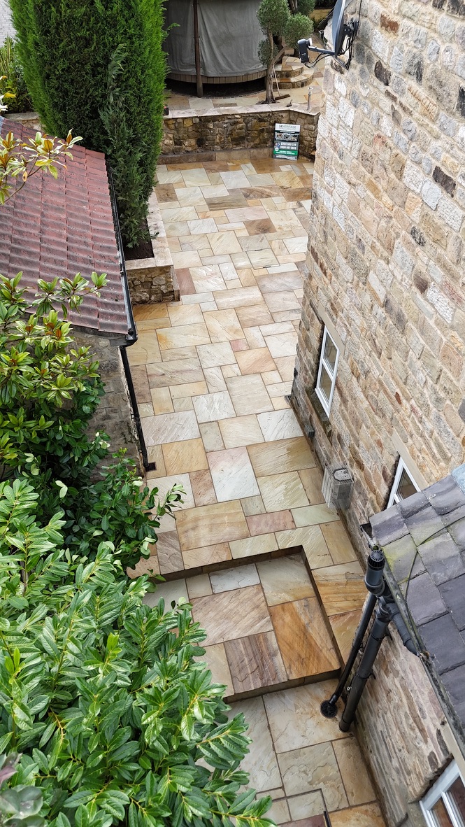 Fossil Mint sandstone paving and steps beside the stone house in Linton