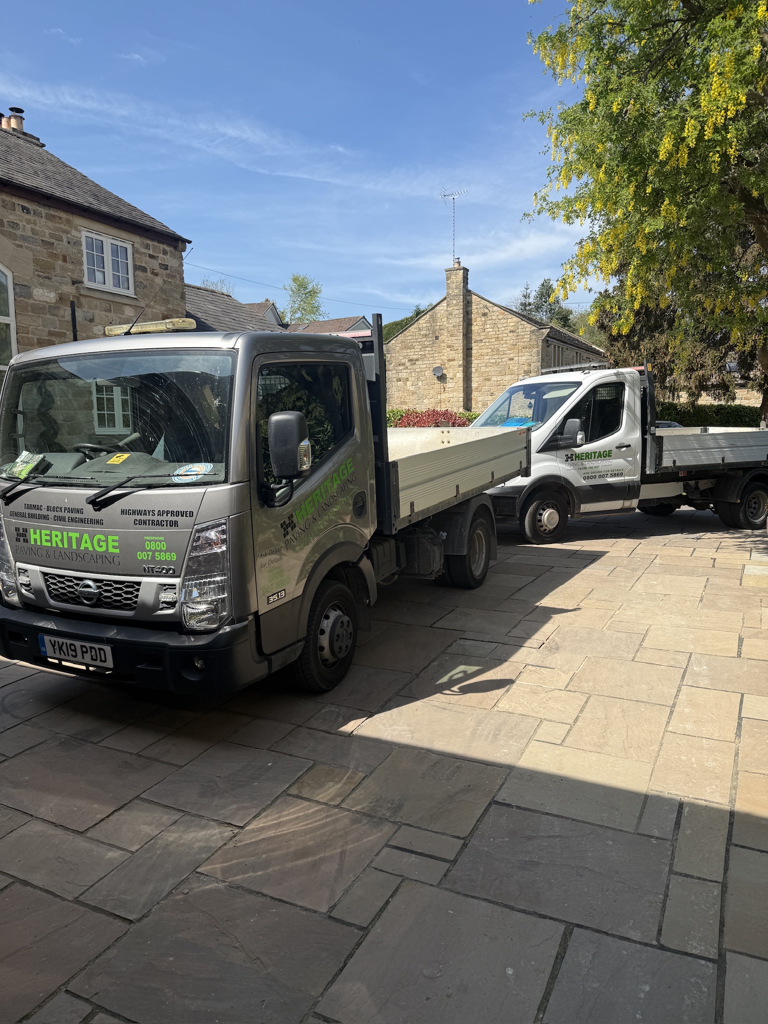Two Heritage Paving and Landscaping vehicles on site