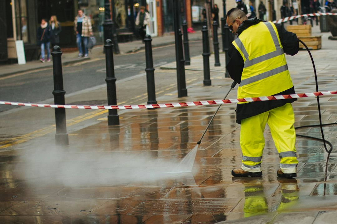 Illustrative stock photo of an operator cleaning commercial outdoor paving