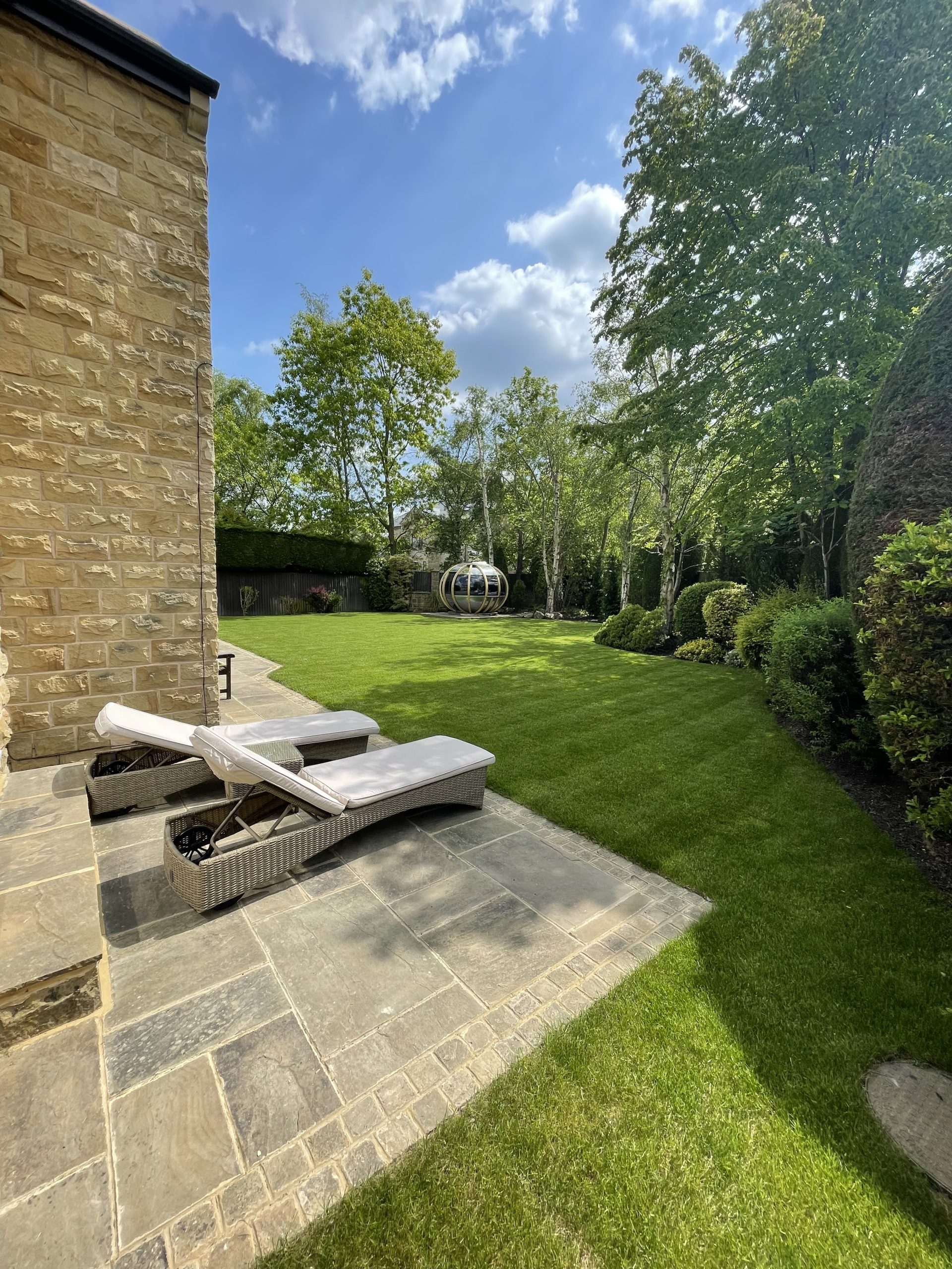 Reused Indian sandstone patio, cobbled edging and finished lawn at Wigton Lane