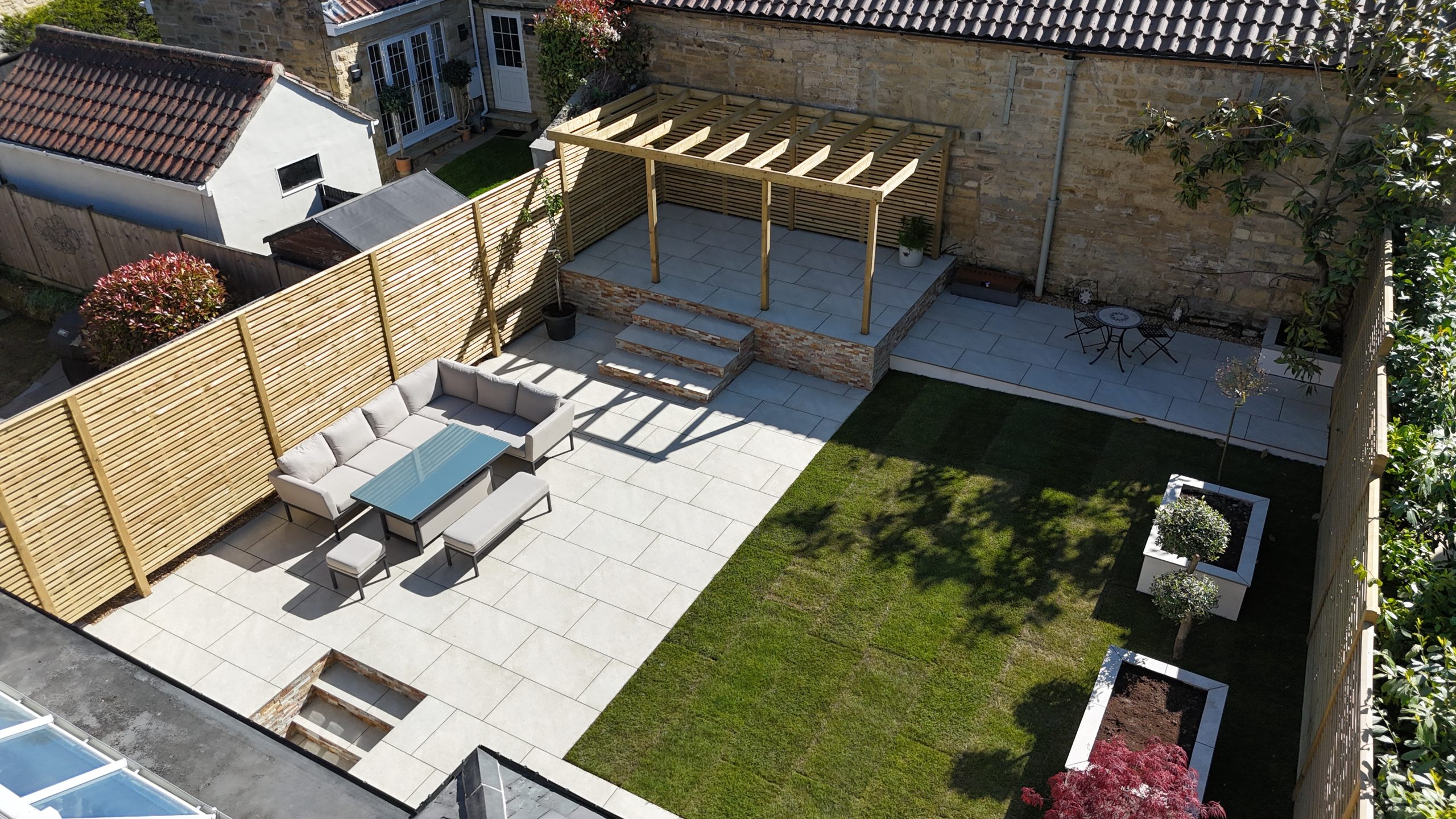 Porcelain patio, pergola, steps and lawn completed by Heritage in Linton