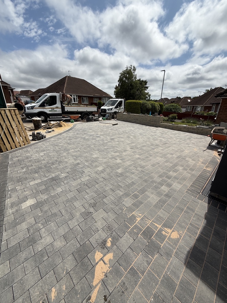 Grey mixed block paving across a wide driveway