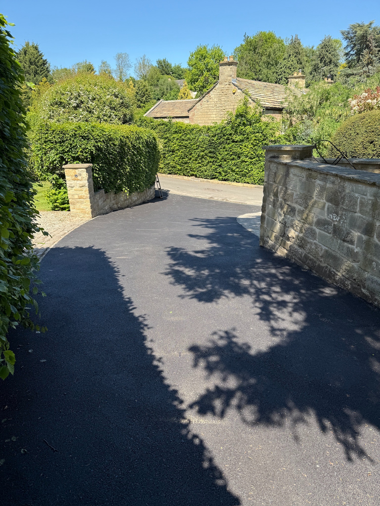 Newly surfaced private tarmac access lane between neighbouring properties in Linton near Wetherby