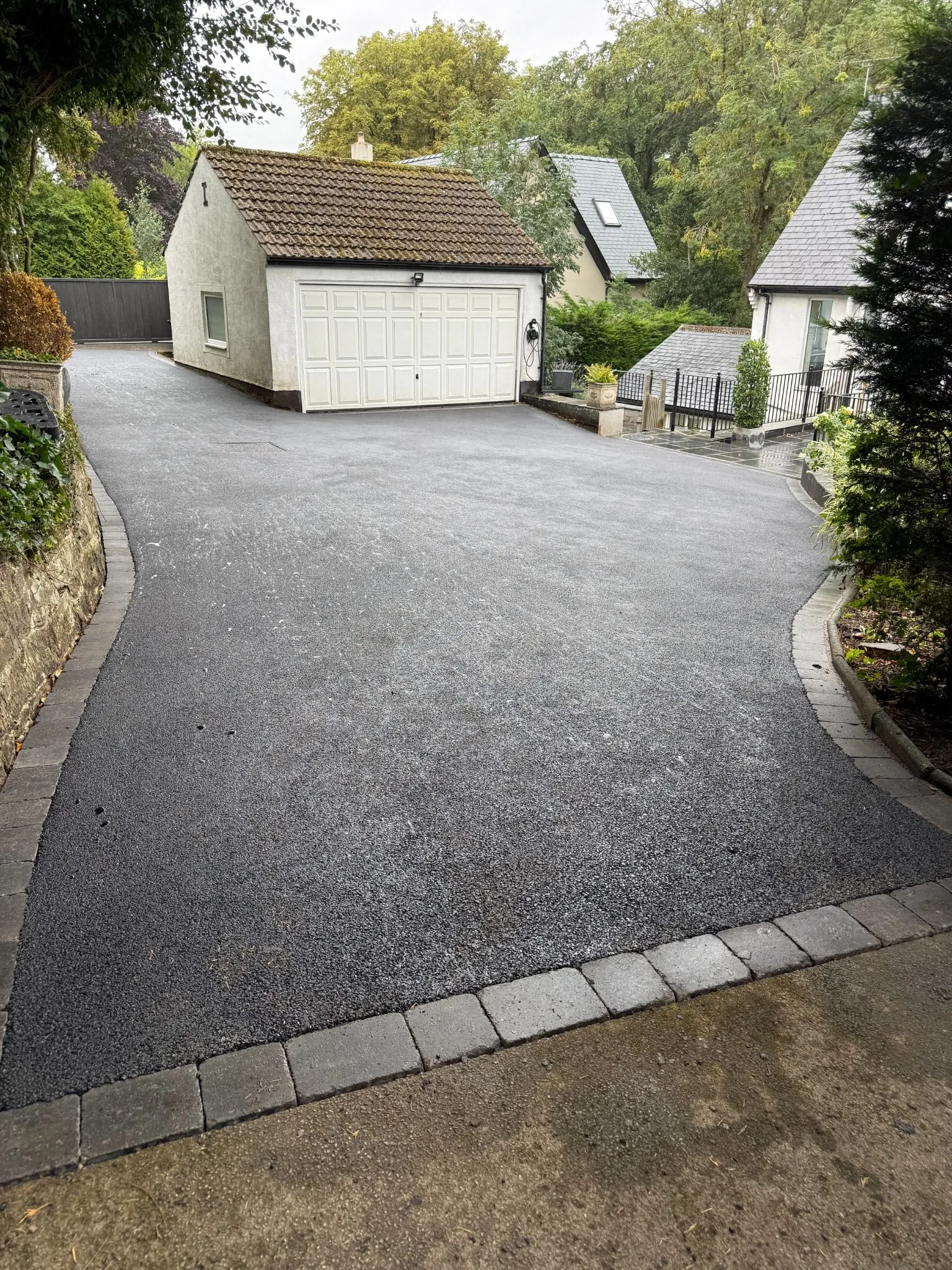 Finished SMA tarmac driveway with block-paved border in Leeds