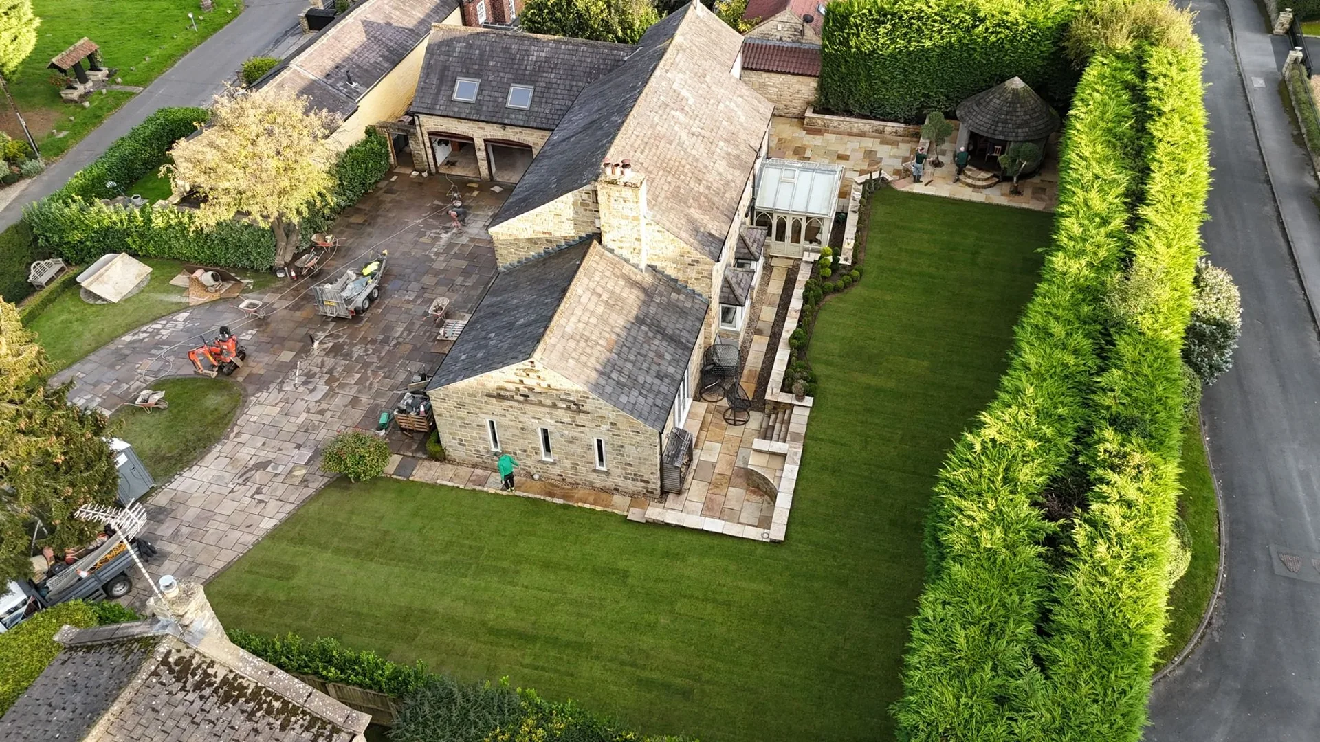 Aerial view of a Fossil Mint Indian sandstone patio and newly turfed garden completed by Heritage Paving in Linton
