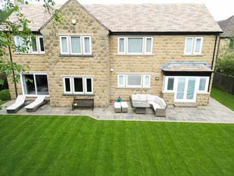 Completed lawn and Indian sandstone patio beside the house — Wigton Lane, Leeds