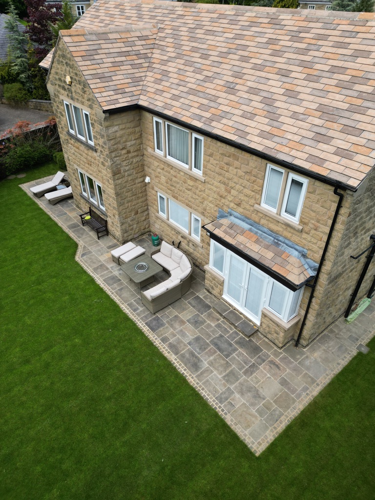 Finished sandstone patio and cobbled border viewed from above — Wigton Lane, Leeds